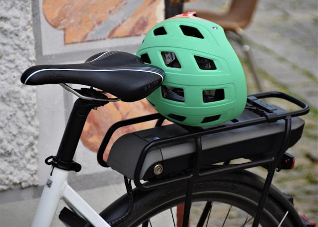 Green and black helmet on a bike handlebar